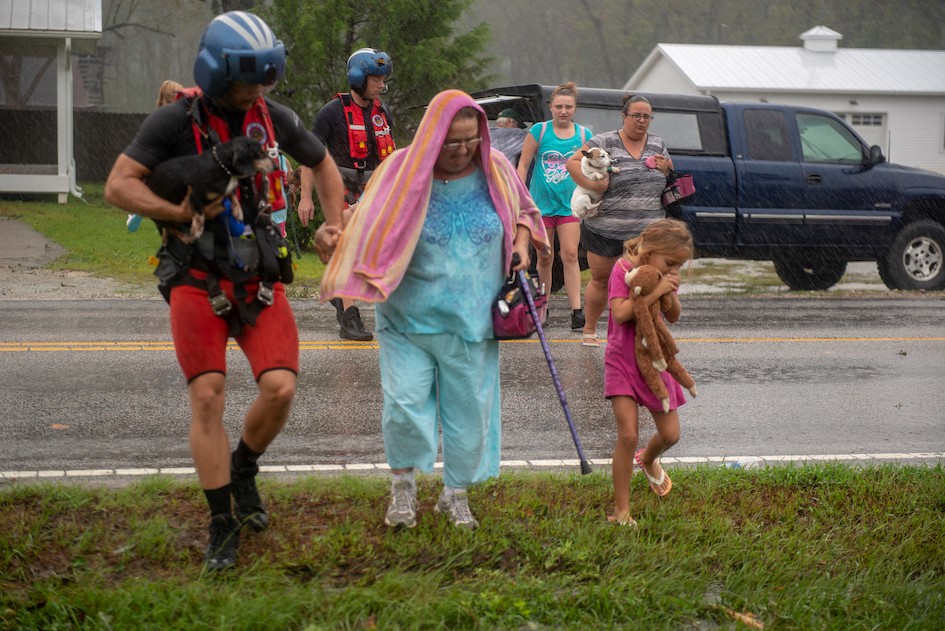 An MH-60T Jayhawk Helicopter crew from Coast Guard Air Station Elizabeth City, North Carolina, evacuates residents from Rocky Point, North Carolina, due to flooding caused by Hurricane Florence. A total of 26 adults, 11 children, 7 dogs and 4 cats were evacuated from the neighborhood. (U.S. Coast Guard photo by Petty Officer 2nd Class Dustin Williams/released) An MH-60T Jayhawk Helicopter crew from Coast Guard Air Station Elizabeth City, North Carolina, evacuates residents from Rocky Point, North Carolina, due to flooding caused by Hurricane Florence. A total of 26 adults, 11 children, 7 dogs and 4 cats were evacuated from the neighborhood. (U.S. Coast Guard photo by Petty Officer 2nd Class Dustin Williams/released)